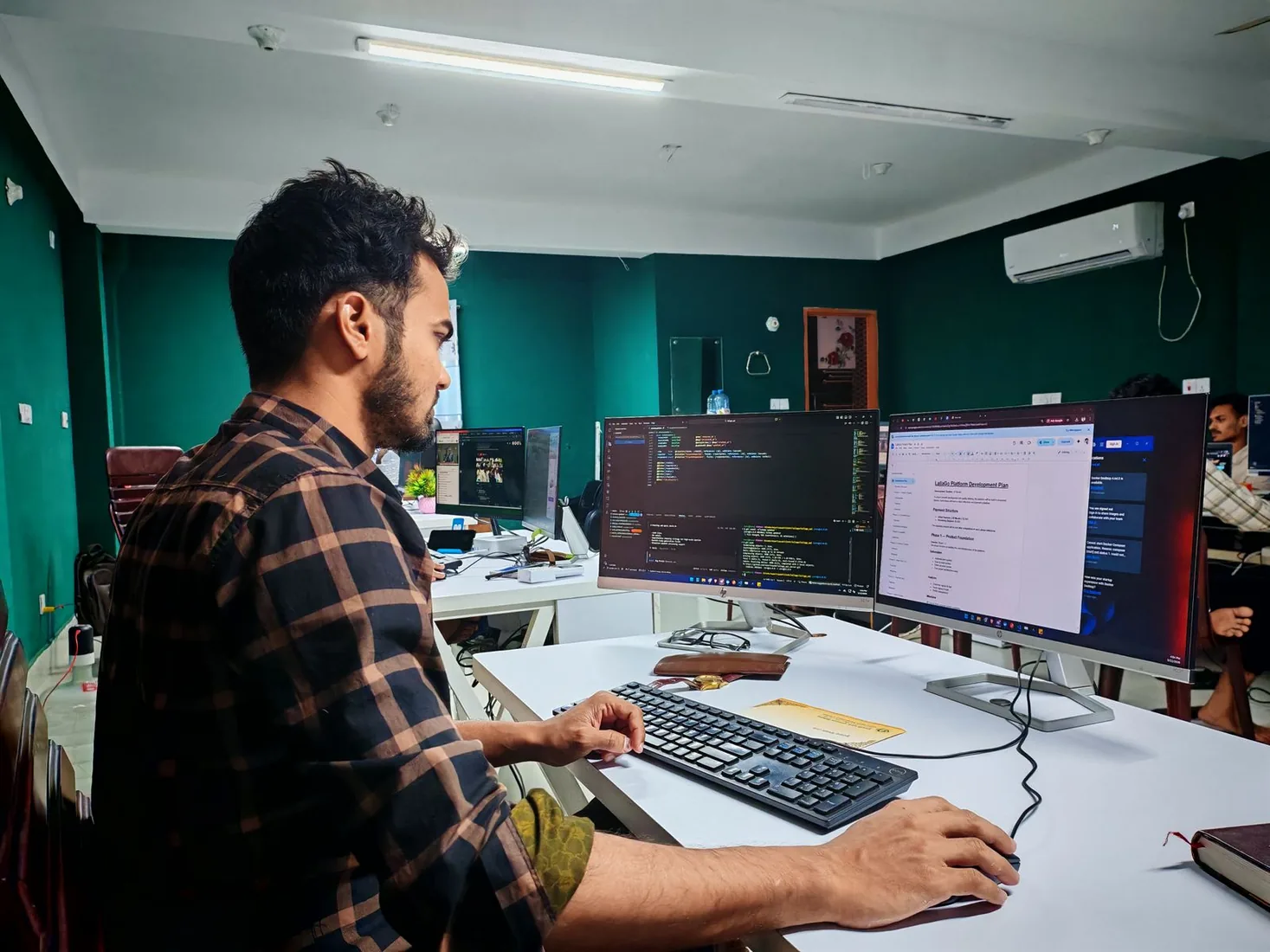Illustrative software developer working at a coding workstation